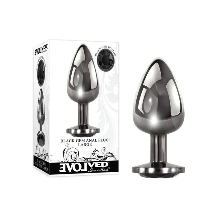 metal tapered anal plug with a black gem on the base next to its boxed packaging