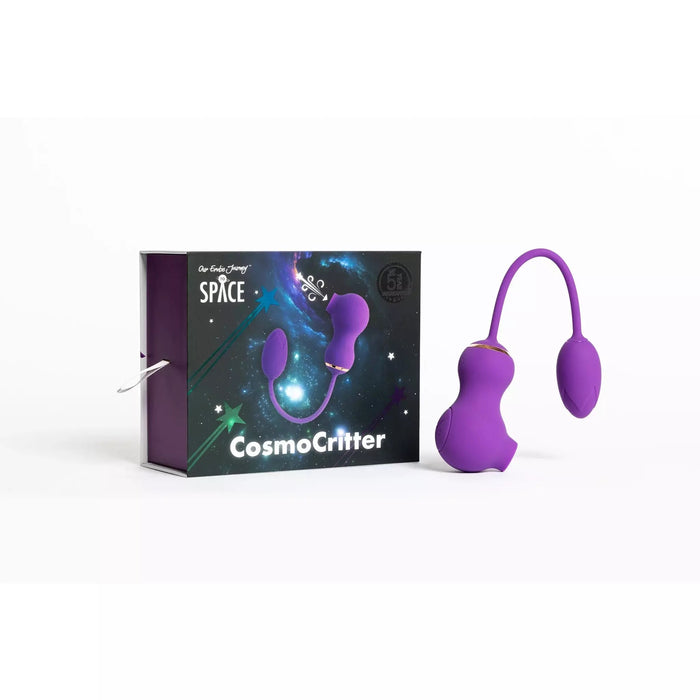 purple dual kegel ball with suction and tail next to box