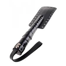 a large black paddle with silver studs along the edge and a black wrist strap