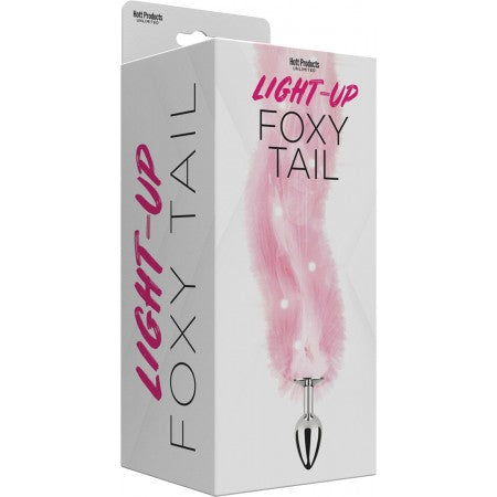 pink fox tail on silver anal plug on box cover