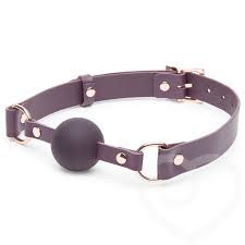 a purple ball gag with purple straps that have gold fasteners