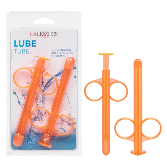 a orange lube dispensing syringe next to its additional tube, shown next to its plastic packaging