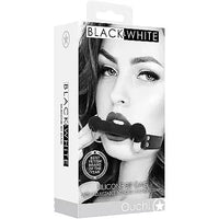 a black and white box depicting a woman wearing a black bar gag with black straps