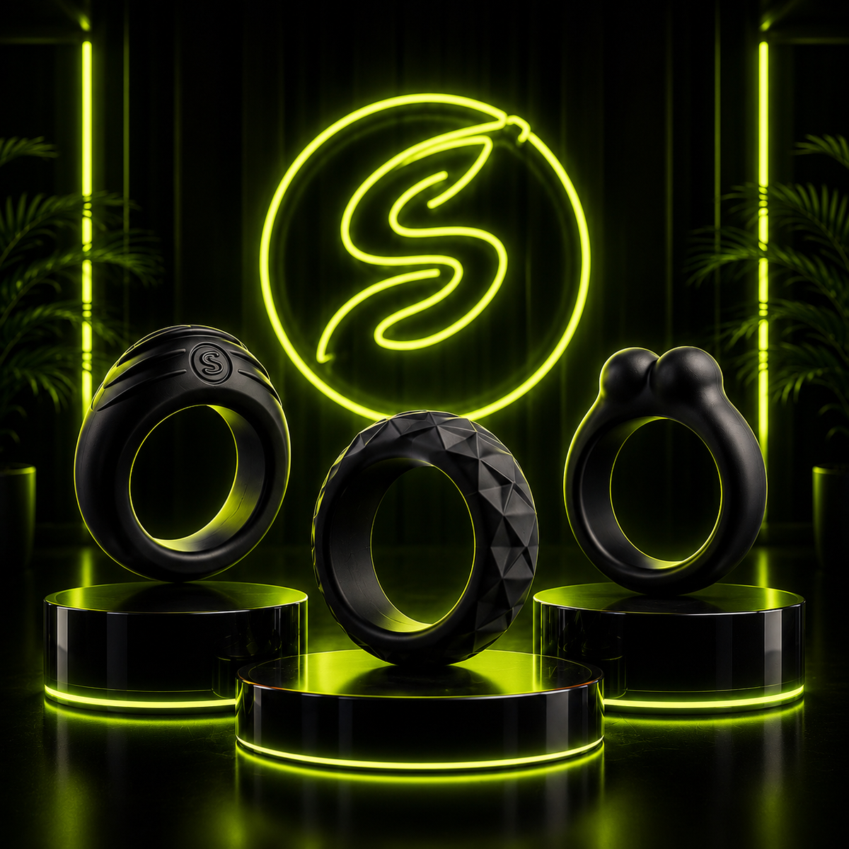 Three black silicone adult wellness rings with different textures and designs displayed on illuminated podiums, set against a dark background with neon green lighting and a glowing “S” logo.