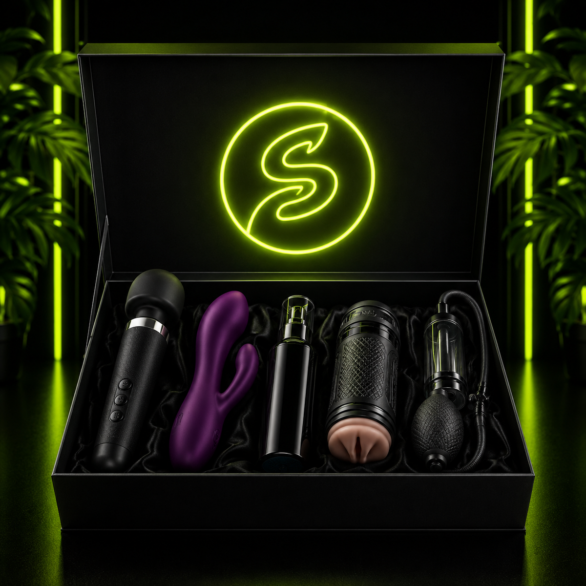 Open black gift box lined with satin, featuring a neon green logo and a selection of adult wellness products, set against a dark background with green accent lighting.