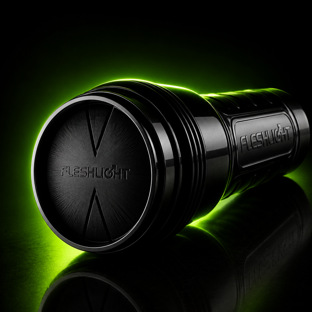 Black Fleshlight adult wellness product photographed on a glossy dark surface, with neon green backlighting creating a dramatic product-style glow.