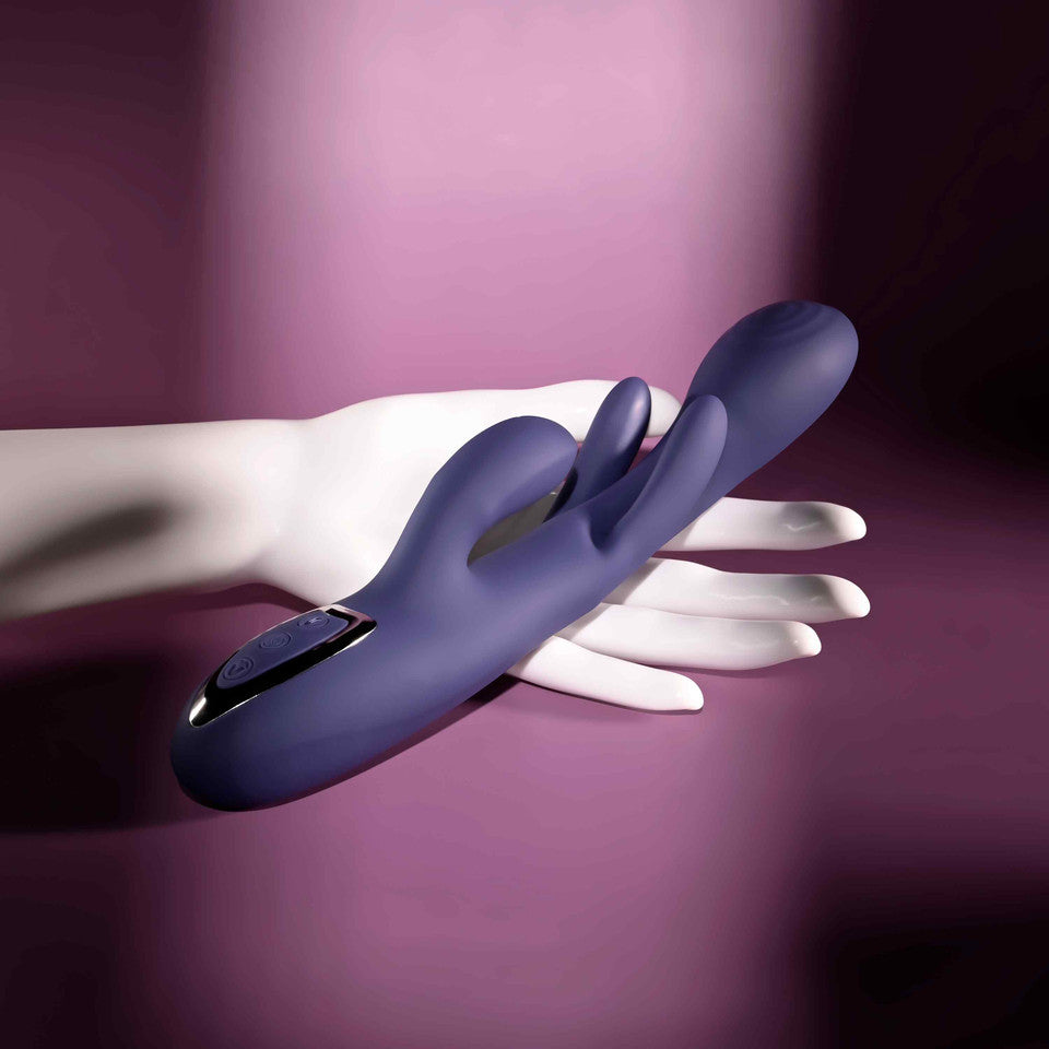 Purple bow down come hither vibrator against hand example photo.