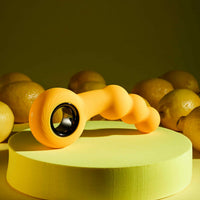 Yellow bumble vibrating anal plug with ring safety base and 12 vibration settings inside packaging.
