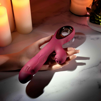 Burgundy vibrator against hand example photo.
