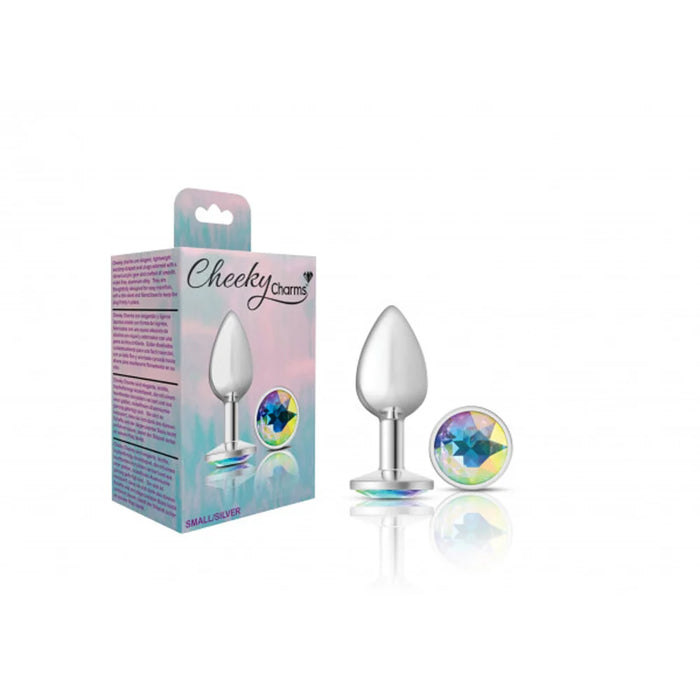 Silver metal anal plug with blue gem beside packaging.