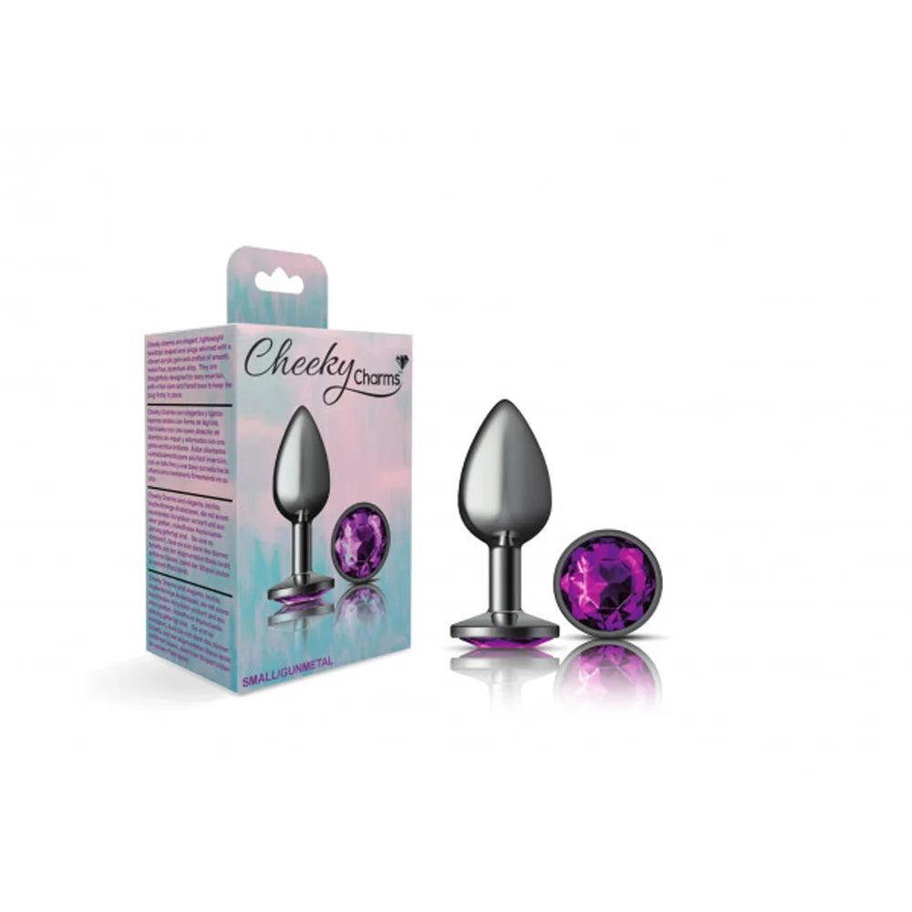 Silver metal small anal plug with purple gem beside packaging.