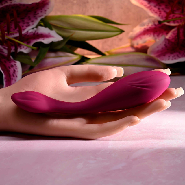 Pink cherry pose vibrator against hand example photo.