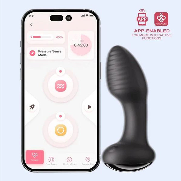 Black anal vibrator beside smart phone