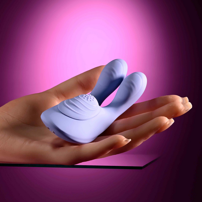Vibrating massager purple against hand example photo.
