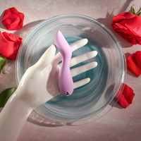 Lilac pink G G-spot vibrator sizing photo against hand.