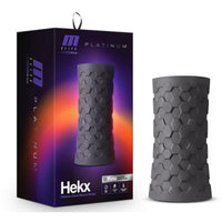 purple and orange packaging next to the black masturbator with a helix design on it's exterior