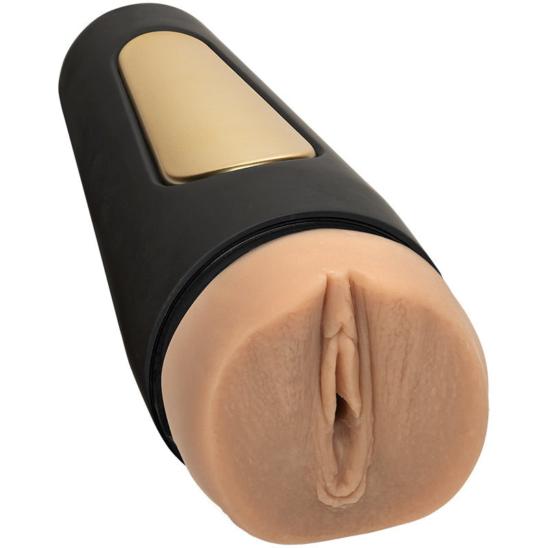 Beige masturbator with a black hard shell with a gold squeezable section and a vaginal opening 