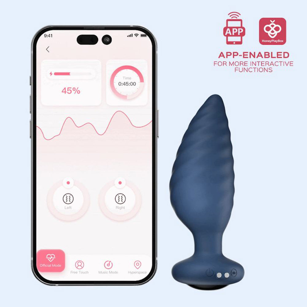 Blue rotating butt plug beside smart phone