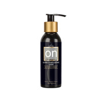 Black bottle with gold pump labeled 'on' insane ultra-stimulating-glide on a white background