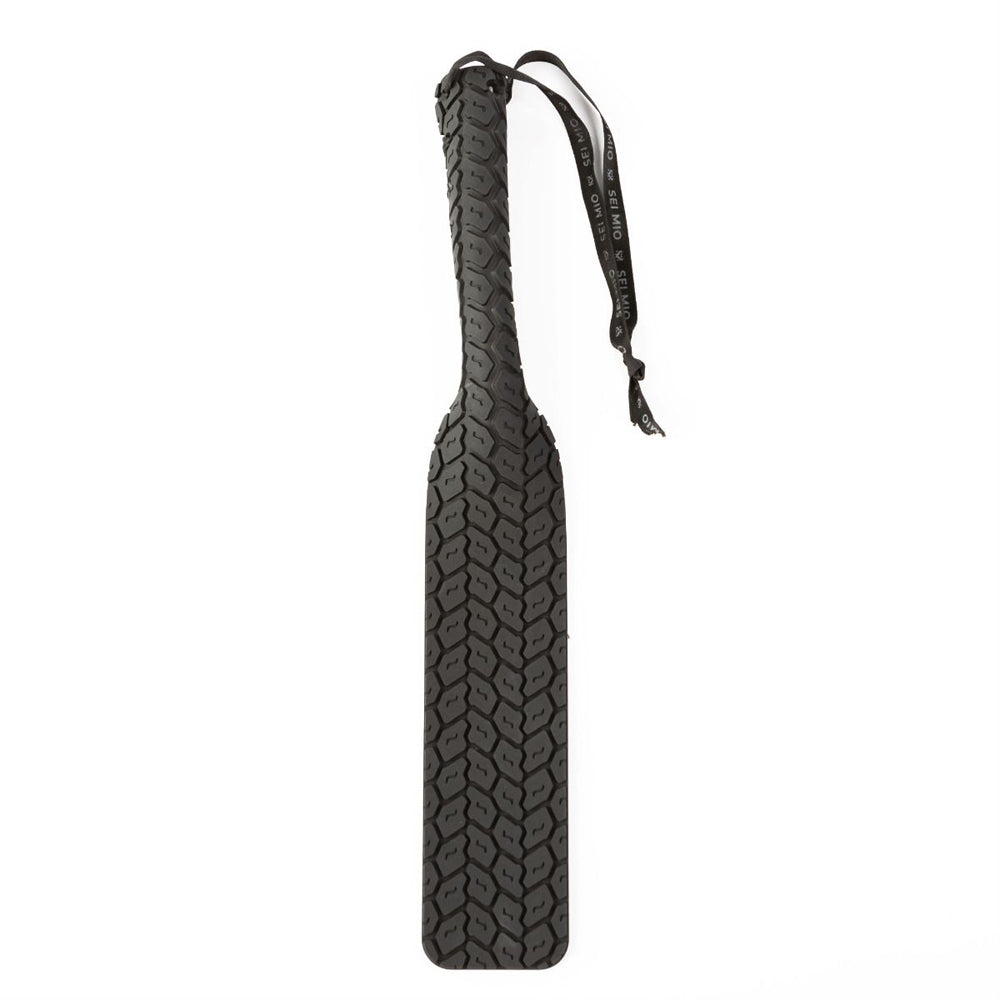 Black spanking paddle featuring textured surface and drawstring example photo.