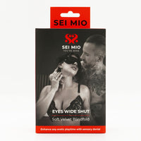 Eyes wide shut velvet blindfold inside packaging.