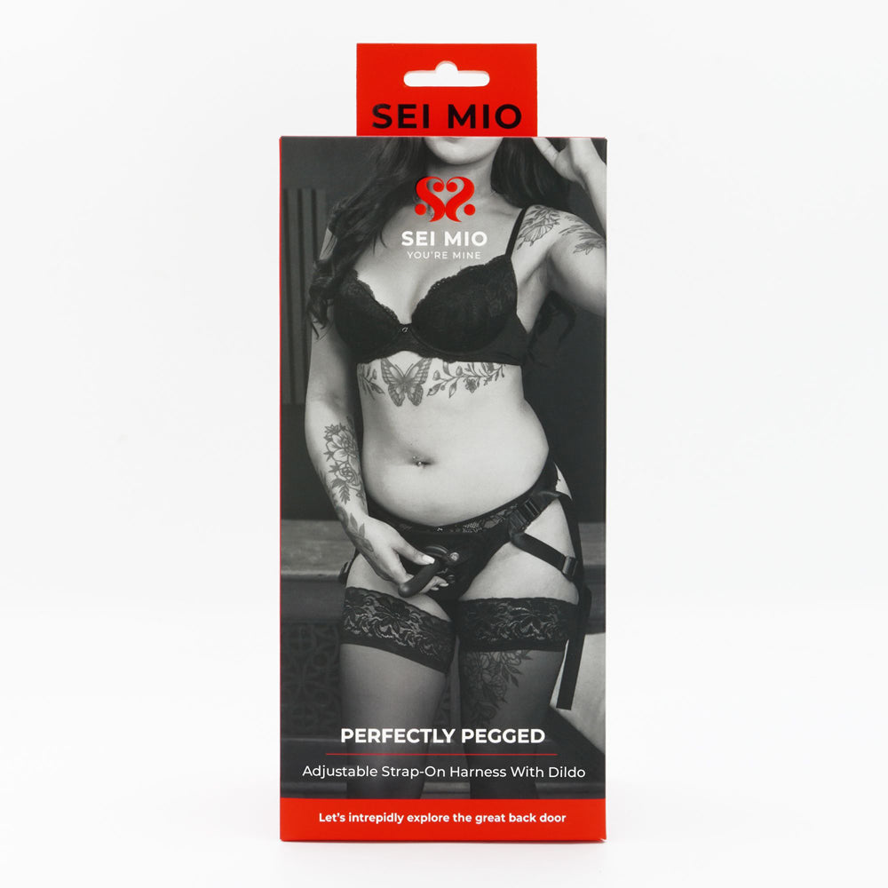 Perfectly pegged adjustable strap on harness with dildo inside packaging.