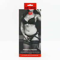 Perfectly pegged adjustable strap on harness with dildo inside packaging.