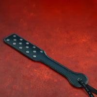 Black studdy hard punishment paddle featuring studs example photo.
