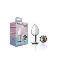 Silver metal anal plug medium with multicolor gem beside packaging.
