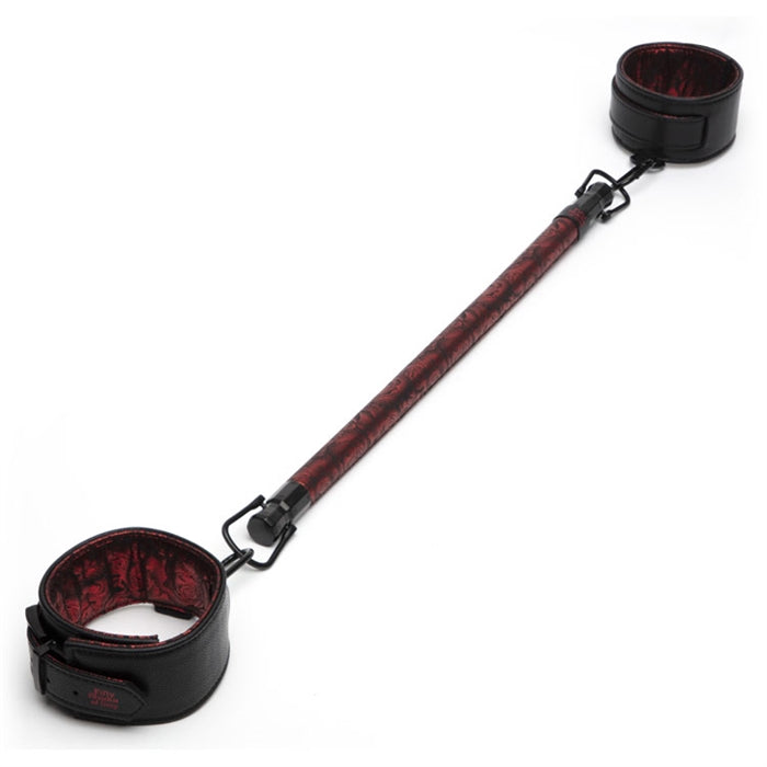 Red spreader bar with red cuffs attached