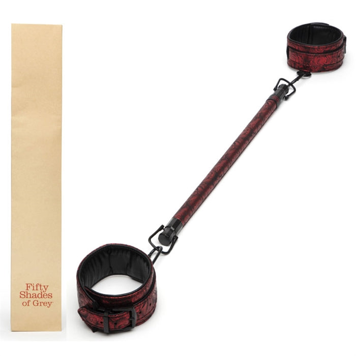 Red spreader bar with red cuffs attached