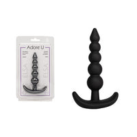large anal plug with beads beside packaging