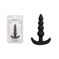 black anal plug with beads med beside packaging