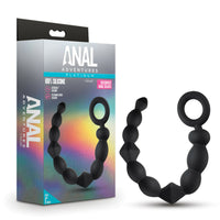 Black silicone ring with 'Anal Adventures' packaging on a white background