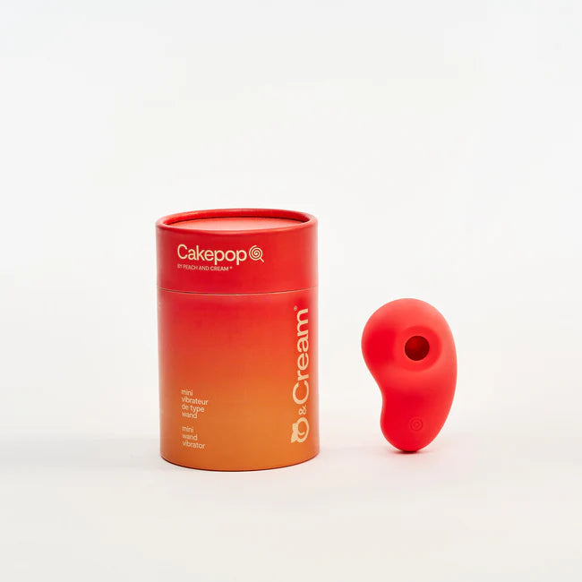 Red cylindrical container with  branding aura clitoral air pulse vibrator on a white background