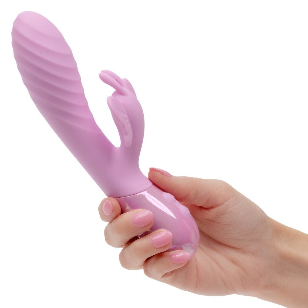 Pink aura dual flutter butterfly vibrator held by a hand on a white background