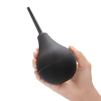 black anal douche held in hand