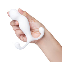 white curved anal plug held in hand