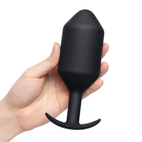 large tapered anal plug with curved bottom base, held in hand