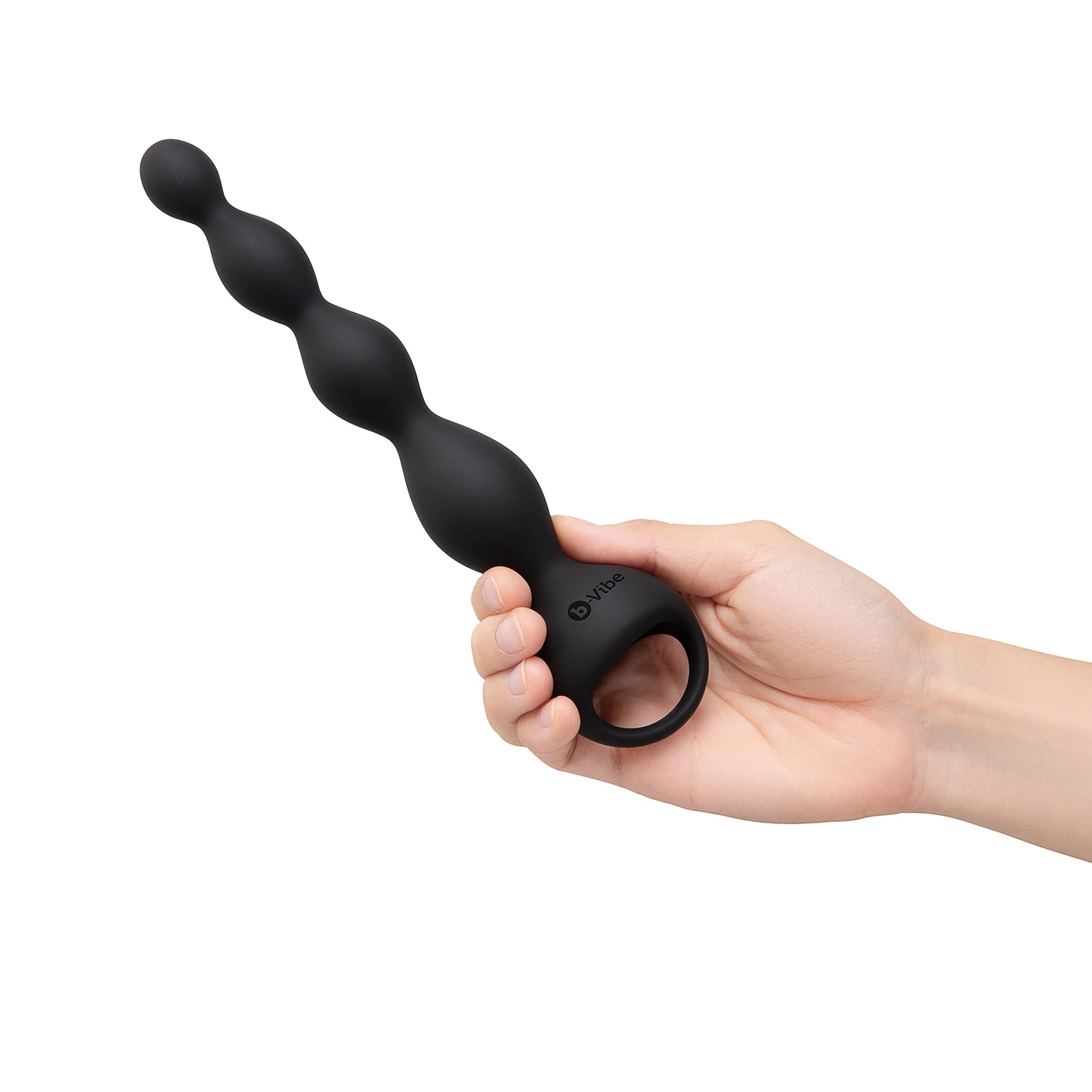 Black silicone anal beads held in a hand on a white background