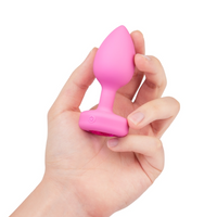 pink butt plug held in hand