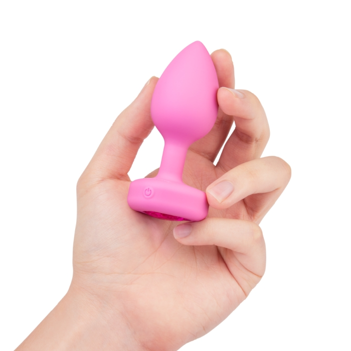 pink butt plug held in hand