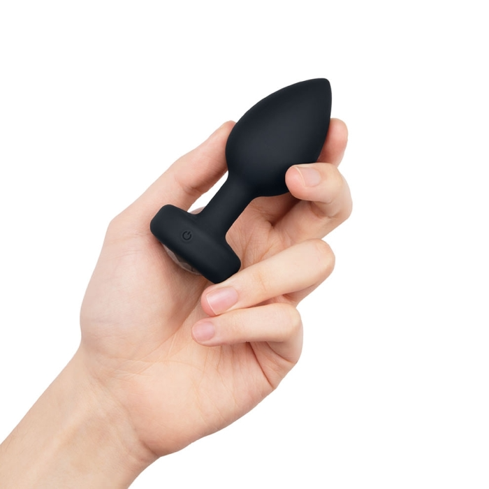 black tapered anal plug held in hand