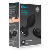black anal plug with clear jewel on bottom, with remote control, on box packaging