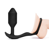 Black silicone butt plug on a white background