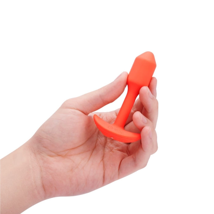 orange slim neck anal plug held in hand