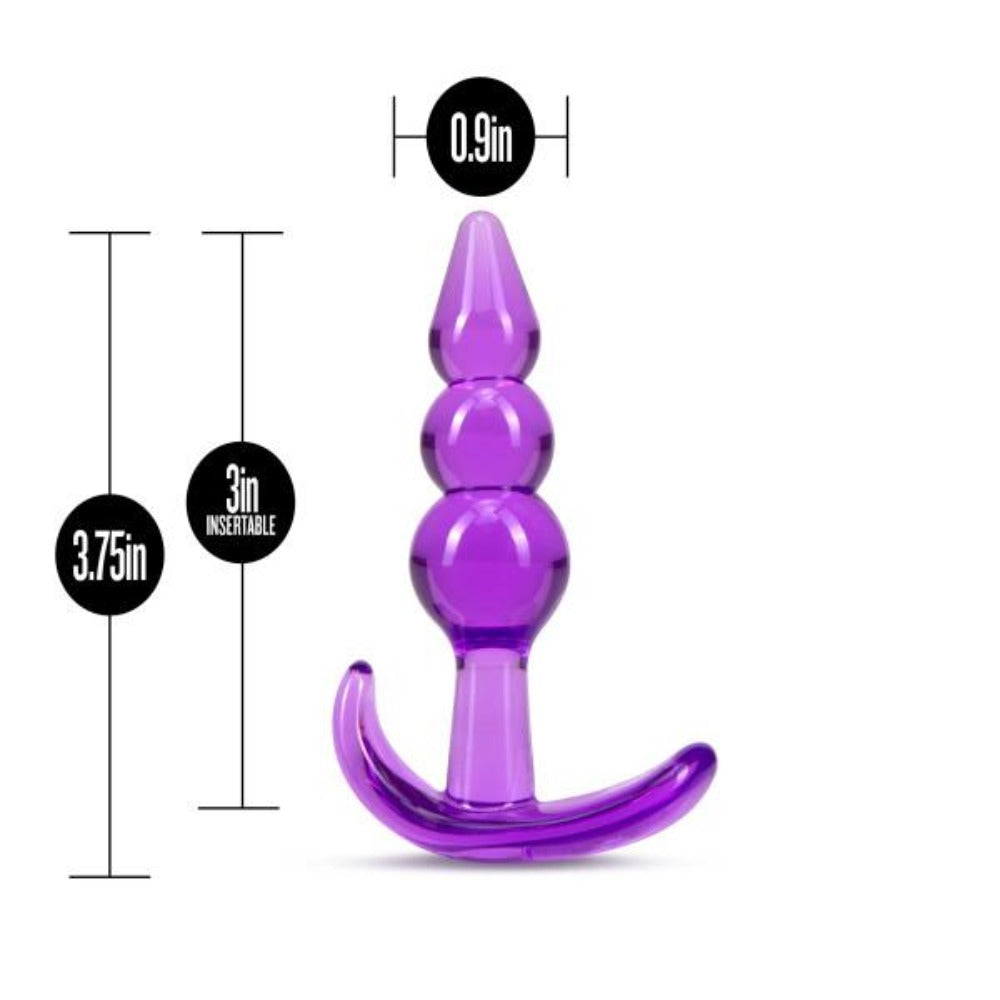 Purple silicone butt plug with measurements on a white background