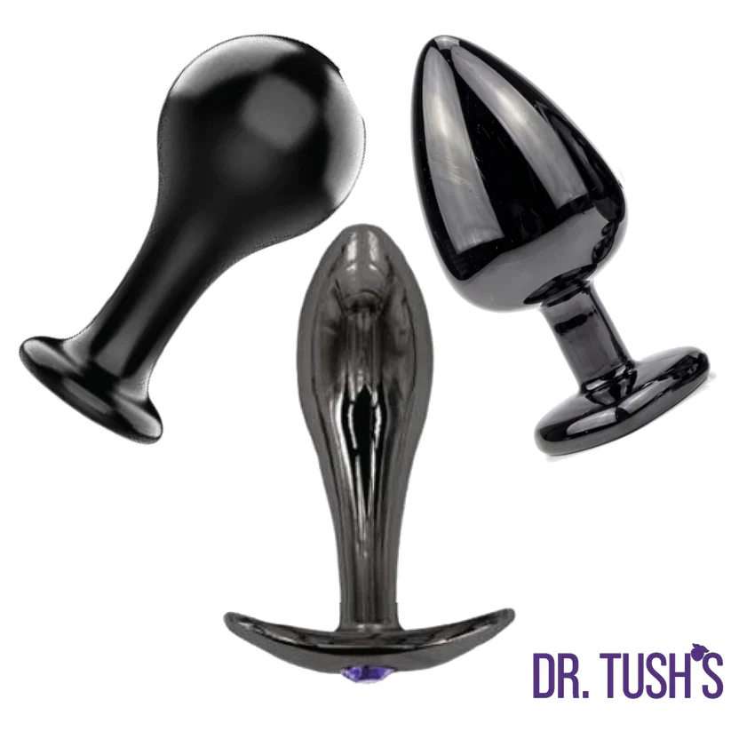 Dr. Tush’s Bad Decisions Collection featuring three glossy black metal anal plugs in Classic, Knob and Ridges shapes with flared bases.