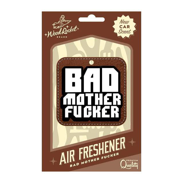 This image features the "Bad Mother Fucker" air freshener by Wood Rocket, presented in a bold and humorous packaging. The air freshener itself is designed with a striking black and white text on a brown cardboard cutout, emphasizing its edgy and irreverent aesthetic.