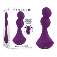 A purple anal plug with two stacked silicone balls, a velvet-smooth texture, and a black chrome-finished detail at the base. The packaging shows the product name 'Ball Game' and highlights its vibrating and rotating features.